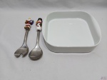 Lote composto de travessa quadrada em porcelana branca com par de talher de salada em aço inox com motivo natalino. Medindo 26cm x 26cm x 6cm de altura.