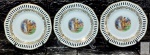 BAVÁRIA - GERMANY - Trio (03 unidades) de pratos decorativos em porcelana alemã (fenestrados perfeitos, nenhum defeito) decorados por cenas idílicas em rica policromia e detalhes. Medem 15,5 cm de diâmetro cada.