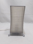 Luminária de mesa em ferro revestido de borracha transparente. Medindo 12cm x 12cm x 26cm de altura.