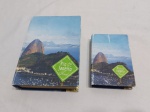 Lote de 2 caixas retangulares a forma de livro em madeira com revestimento, imagem da cidade do Rio de Janeiro. Medindo a maior 20cm x 14cm x 5cm de altura.