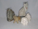 Quatro esculturas em cerâmica vitrificada representando animais sendo 2 figuras de cães, 1 elefante e 1 cabeça de cavalo. Maior 27 x 15 x 9 cm, menor 14 x 18 x 7 cm.