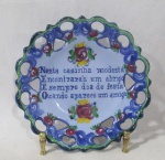 PORCELANA - Um prato decorativo em porcelana portuguesa vitrificada e policromada, ornamentado com decorações vazadas, bordas recortadas, marcado no fundo. Medida: 19,5 de diâmetro.