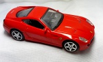 Colecionismo- Miniatura de uma FERRARI 599 GTB FIORANO vermelha,  em metal com detalhes em plástico,  pneus em plástico,  medindo 10,5cm.