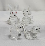 Cristal- Quatro miniaturas de bibelôs em cristal sendo um Coelho,  um elefante,  um carneiro e um passarinho, medindo de 2cm a 5cm.