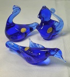 Cristal - Três  peças em cristal azul cobalto sendo um cisne medindo 8cmX8cm, uma pomba medindo 13,5cmX4,5cm e um esquilo medindo 7cmX6cm.