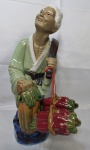 Cerâmica-Estatueta representando um ancião oriental carregando potes de água,  ricamente detalhada em cerâmica vitrificada, medindo 35cm de altura.