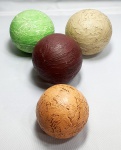 Cerâmica-Quatro bolas podendo ser usadas como peso para papel ou enfeite de centro de mesa provavelmente em cerâmica patinada em resina, medindo a maior 8cm de diâmetro cada e a menor 6,5cm de diâmetro.