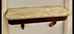 Console de parede com tampo retangular em mármore. Saia e suportes laterais em madeira, esculpidos com frisos e folhagens.  Medida do console: C = 85 cm x P = 30 cm