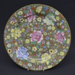 HUI YUAN - Belíssimo prato oriental em porcelana com tom dourado pintado a mão decorado com peônias(figuras florais), bem conservado. Medida: 25,5 cm de diâmetro.