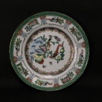 ARTE ORIENTAL - Belo prato em porcelana esmaltada  decorado com  casal de aves ao centro, ladeado com arabescos, galerias e arranjos florais pintados à mão. Exemplar de coleção. Dimensões: 20 cm.