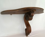 Antigo console em madeira com base esculpida e detalhes em volutas. Med. 74X30cm e 44cm de altura. Apresenta desgastes e bicados.