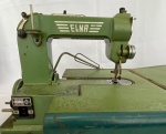 ELNA - Antiga máquina de costura suissa elétrica portátil. Metal na cor verde, acondicionada em estojo. Medida do estojo: altura 30 cm, comprimento 35 cm, largura 18 cm. Funcionando - Apresenta desgastes. Máquina utilizada por soldados alemães na segunda guerra mudial para consturar suas fardas. 