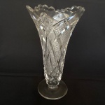 Vaso para flor de cristal europeu translúcido lapidado com estrelas com bocal recortado. Med.: 20,5cm de altura e 12cm de diâmetro. Possui bicados na base e bocal.