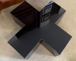 Mesa de centro em acrílico, tonalidade preta,  na forma de X. 99 x 99 x 36 cm de altura