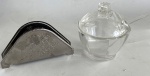 2 peças: Meleira de acrílico com colher e porta guardanapo de inox. Meleira: 9,5 cm de diâmetro x 10,5 cm de altura
