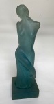 Escultura provavelmente de resina na tonalidade azul celeste, representando mulher. 11,5 x 12,5 cm na base x 40 cm de altura