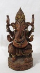 ESCULTURAS - Escultura de origem Indiana em madeira ricamente entalhada, representando Deus Hindu Ganesha. Medidas alt 20,5 cm x diam da base 9.
