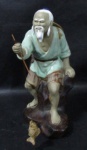 ESCULTURAS - Uma escultura oriental em porcelana vitrificada, ricamente detalhada e policromada, representando "pescador". Medida: 22,5 cm de altura total.
