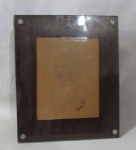 FOTOGRAFIA - Porta retrato em madeira, com frente em vidro translúcido e apliques de pequenas flores, com desenho realista retrato, assinatura não identificada no CID, medindo: 28 cm de altura x 23,5 cm de largura. Possui marcas de uso, e vidro com bicados na borda.