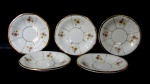 PORCELANA MAUÁ - Cinco pires em porcelana nacional vitrificada branca, decorados com motivos vegetalistas em rica policromia e frisos dourados, bordas generosamente filetadas à ouro, marcados no fundo, medindo: 11,3 cm de diâmetro. Apresenta falhas na douração.