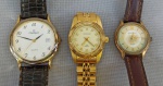 RELÓGIOS, três (3) distintos de pulso, movimento quartz, sendo: 2 da marca MONDAINE (Mondaine Watch Ltd., relojoaria fundada em 1944, por Hans Hilfiker, em Zurique, Suíça), um deles com caixa, tampa e pulseira em aço, partes com douração, outro com caixa em metal dourado, tampa em aço e pulseira em couro (faltando a fivela); 1 da marca CHAMPION, mostrador branco com algarismos arábicos e calendário, caixa em metal dourado, tampa em aço, pulseira em couro, usados, parados, aparentemente em bom estado, possivelmente demandam nova bateria e sem garantia.