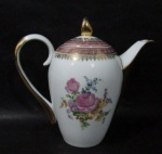 PORCELANA SCHMIDT - Um bule para café em porcelana vitrificada branca, decorado com motivos florais em rica policromia ao centro, seguido de bordas adornadas com guirlandas de folhas e arabescos, generosos filetes e gregas em pintura à ouro, sobre faixa esmaltada na tonalidade rosa, pega da tampa em forma estilizada,  alça vazada e bico arrematados com vasta douração, marcado no fundo. Med.: alt total 22 cm x larg total 24 cm. Em ótimo estado!