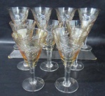 CRISTAL - Nove taças em cristal da manufatura HERING na cor champanhe decoradas com motivos vegetalistas, haste facetada apoiada sobre pé circular. 2 taças apresentam bicados Medida 13,5 x 7 cm.