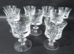 CRISTAL - Nove taças para água em demir cristal bojo circular ricamente trabalhado com caneluras , losangos e palmas apoiado sobre pé circular. Uma taça com tamanho menor 12 cm X 8 cm. 1 taça com bicado. Medida 13 cm X 9 cm.