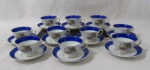 PORCELANA - REAL S. PAULO - Dez xícaras para café com seus respectivos pires, em porcelana nacional vitrificada branca, apresentando cena galante em rica policromia ao centro, seguida de friso dourado, bordas ligeiramente onduladas e adornadas com larga faixa na tonalidade azul, finalizando com filetes em pintura à ouro, alças trabalhadas em folhas com vasta douração, apoiadas sobre pé bolacha, marcados no fundo. Med.. xícaras: alt 4,3 cm x diam 7 cm/ pires: diam 10,3 cm.