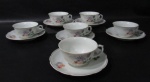 PORCELANA REAL S. PAULO - Seis xícaras para chá com seus respectivos pires, em porcelana vitrificada branca, delicadamente decorados com motivos vegetalistas em exuberante policromia, bordas movimentadas e filetadas à ouro, alças vazadas finalizando em volutas, marcados no fundo. Medidas: xícaras: alt 5 cm x diam 9,5 cm/ pires: diam 14,5 cm. Uma com ínfimo bicado e uma com pequenas falhas na esmaltagem das bordas.