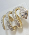 ANEL COBRA CONFECCIONADO EM OURO AMARELO 18K, COM DETALHE EM OURO BRANCO 18K, COM 100 DIAMANTES COM 1,2 PONTOS CADA, TOTAL DE 1,20 CT, PESO: 11,5g, TAMANHO: 17, ANEL TAMANHO AJUSTÁVEL, VALOR DE MERCADO: R$ 12,500,00