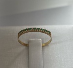 MEIA ALIANÇA CONFECCIONADA EM OURO AMARELO 18K, COM 9 ESMERALDAS NATURAIS, PESO: 0,7g, VALOR DE MERCADO: R$  1.650,00