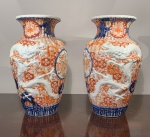 ARTE ORIENTAL - PAR DE VASOS EM PORCELANA DECORADA PADRÃO IMARI. DRAGÃO EM RELEVO E CORPO CANELADO. PRESENÇA DE RESTAURO AMADOR EM UMA DAS BORDAS. MEDIDAS: 32 CENTÍMETROS DE ALTURA POR 18 DE DIÂMETRO.