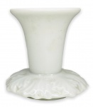 EUROPA - Elegante castiçal em porcelana branca esmaltada ricamente adornado com arabescos na base. Possui registro da manufatura na base. Mede 7cm de altura x 8cm de circunferência.