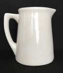 D. PEDRO II - Elegante leiteira em porcelana branca esmaltada com alça. Apresenta registro da manufatura. Possui fio de cabelo na alça. Mede 18cm.