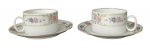 Duas elegantes xícaras para chá em porcelana branca adornada com motivo floral em policromia e arabescos. Acompanha seus respectivos píres. Possui registro da manufatura na base.