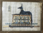 Antiga obra em papiro representando figura de cão egípcio, pintada à mão. Assinada no canto inferior esquerdo. Moldura apresenta desgastes. Medida total 34 x 44 cm.