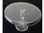 Prato para bolo executada em vidro, base circular com saia ondulada apoiado em haste sustentada por base circular, Diam. 33, Alt. 12 cm.