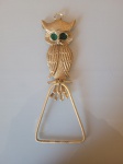 Antigo pendurador de toalhas, feito de metal amarelo e os olhos da coruja verdes de material sintético . A peça  se encontra em excelente estado de conservação. Altura da coruja:15cm     Largura da coruja:6cmAltura do gancho:10cm   Largura da parte de baixo do gancho :8cm