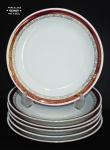 PORCELANA RENNER - Seis pratos rasos em porcelana branca nacional, com borda na cor rouge de fer adornada por flores em folha de ouro. Med.: 25cm.