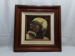 Quadro de óleo sobre cerâmica com moldura em madeira, retratando um preto velho. Medindo a moldura 60cm x 60cm.