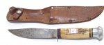 5 - FACA MUNDIAL DE CAÇA, LÂMINA AÇO CARBONO SEM GRAVAÇÃO, CABO EM OSSO LAVRADO, COMPRIMENTO TOTAL23 CM, LÂMINA 12 X 2,5 CM