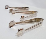 Lote composto por três pegadores de gelo executados em metal prateado de ótima fundição. Medem 16 cm de comprimento. Bom estado de conservação.