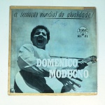 Vinil  Domenico Modugno  A sensação mundial da atualidade!.  Produto Original. Gravadora Fonit Sinter. Fabricado e distribuído por Companhia Brasileira de Discos. Capa (desgastes do material faltando algumas partes, escurecida, com pontos de oxidação e assinatura)/contracapa (com desgastes do material, pontos de oxidação, escurecida e com rasuras) em regular estado de conservação, danificada nas bordas colada com fita adesiva, manchas/pontos de oxidação, marcação do disco, com sinais de uso, manuseio e desgastes. Não contém plástico de proteção do disco. Disco com riscos, mesmo que superficiais podem ocasionar algum nível de ruído na audição. Não contém encarte. Lado A  6 faixas; Lado B   6 faixas.
