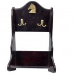 Antigo suporte de parede, em madeira com aplique em bronze no formato de cabeça de cavalo e dois ganchos. Medida: 38cm x 22cm.