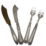 Conjunto de quatro peças: par de facas de peixe e garfos de peixe, em metal espessurado a prata. Medidas: facas 22 cm, garfos 18 cm.