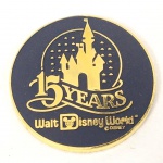 MEDALHA comemorativa ao 15 (décimo quinto) aniversário da WALT DISNEY WORLD. Feita em metal dourado. Mede aprox. 3,1 cm de diâmetro.