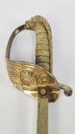 RARO SABRE DA ARMADA IMPERIAL MODELO 1856. ESPIGA ROSQUEADA AO POMO ZOOMÓRFICO CABEÇA DE LEAO. PEGA EM MADEIRA RECOBERTA COM COURO DE ESQUALO  ENVOLTO POR CORDAME METALICO, COPO DECORADO COM COROA IMPERIAL SOBRE ANCORA DA IMPERIAL ARMADA. BASE DA GUARDA DOBRÁVEL. BAINHA ORIGINALMENTE EM COURO. REFERENCIADA NA PAG. 242 DO LIVRO ESPADAS DO IMPERIO BRASILEIRO DEALFONSO MENEGASSI FILHO. BRASIL, DEC. 1850. 92 CM DE COMPRIMENTO