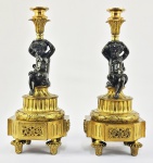 MAGNÍFICO PAR DE LINDOS CASTIÇAIS EM BRONZE ORMOLU ESTILO LOUIS XI. BSAE COM FLORES RELEVADAS E LAURÉU EM COROA. FUSTE COM FEITIO DE QUERUBINS QUE SUSTENTAM AS BOBECHES. FRANÇA, SEC. XIX. 32 CM DE ALTURA