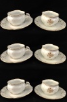 JOSÉ DE SOUZA QUEIROZ NASCIDO EM 1859, FILHO DO BARÃO DE SOUZA QUEIROZ ELEGANTE SEIS XÍCARAS DE CAFÉ COM SEUS PIRES EM PORCELANA COM RICA DECORAÇÃO EM OURO. EM RESERVA, MONOGRAMA ENTRELAÇADO JSQ PERTENCENTE A JULIO DE SOUZA QUEIROZ, FILHO DO BARÃO DE SOUZA QUEIROZ, NETO DO BRIGADEIRO LUIZ ANTONIO, NETO DO SENADOR VERGUEIRO E SOBRINHO DO BARÃO DE PIRACICABA. FRANÇA, SEC. XIX. 10 CM DE DIAMETRO (PIRES).